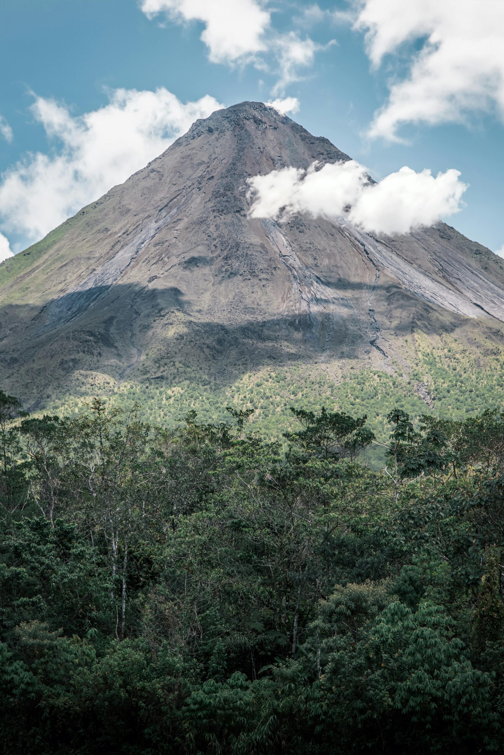 Explore the breathtaking landscape of Arenal Volcano surrounded by lush forest in Costa Rica.